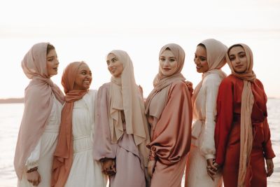 A group of Muslim women wearing hijab and posing for a picture.