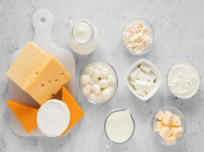 Different types of cheese; displayed in small glass jars and plates.