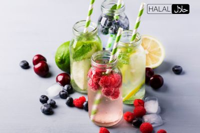 A group of bottles with fruits and ice.